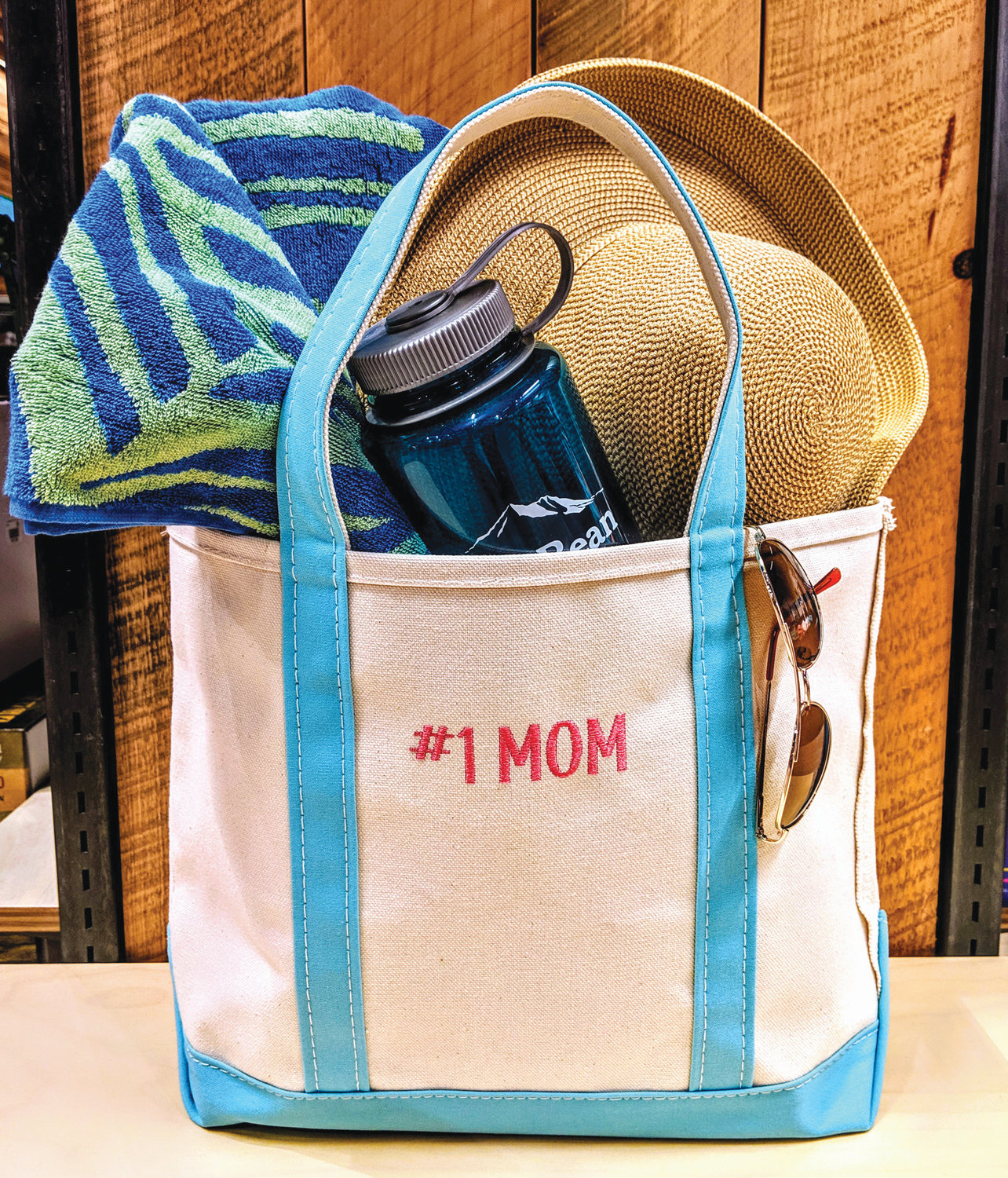 Popular Mother's Day gifts include Yankee Candle's personalized photo candle, engraved jewelry from Providence Diamond Company and the monogrammed tote from L.L. Bean.